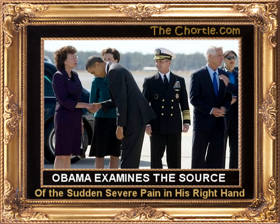 Obama examines the source of the sudden pain in his right hand.