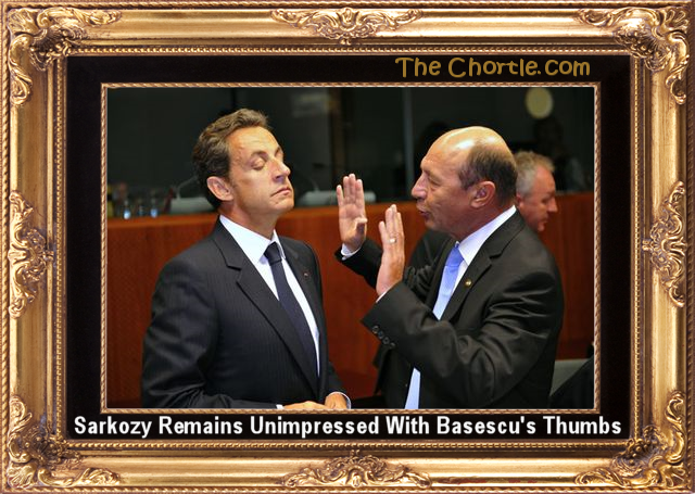 Sarkozy remains unimpressed with Basescu's thumbs.
